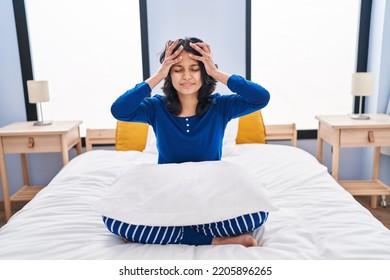 Hispanic Woman With Dark Hair Sitting On The Bed At Home Suffering From Headache Desperate And Stressed Because Pain And Migraine. Hands On Head. 