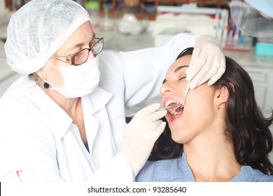 Hispanic Woman At The Dentist With The Mouth Wide Open