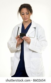 Hispanic Woman Doctor In Her 30s Holding A Pager And Looking Down Reading A Pager