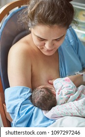 Hispanic Woman Feeding Newborn Close Up Portrait