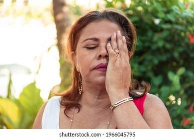 Hispanic Woman Of Fifty Years With Red Hair Cover Face With Hand