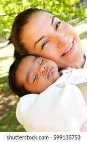 Hispanic Woman Holding Her Baby.