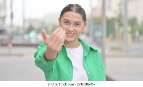 Hispanic Woman Pointing At The Camera And Inviting Outdoor