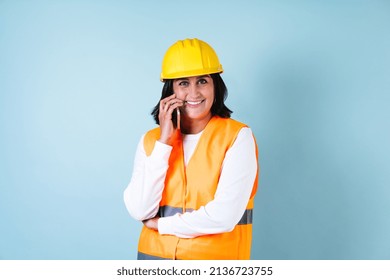 Hispanic Woman Professional Engineering Constructor Builder Talking By Mobile Phone And Worker With Helmet In Mexico Latin America