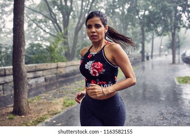 Hispanic Woman Running In The Rain