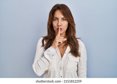 Hispanic Woman Standing Over Isolated Background Asking To Be Quiet With Finger On Lips. Silence And Secret Concept. 