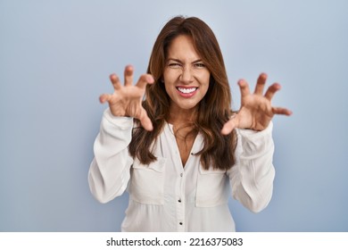 Hispanic Woman Standing Over Isolated Background Smiling Funny Doing Claw Gesture As Cat, Aggressive And Sexy Expression 