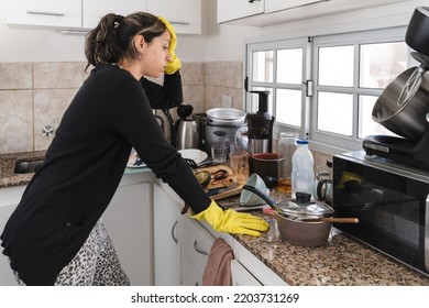 Hispanic Woman Stressed Out About Cleaning Her Messy Kitchen