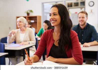 Hispanic woman studying at adult education class looking up