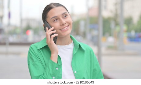 Hispanic Woman Talking On Phone While Standing Outdoor