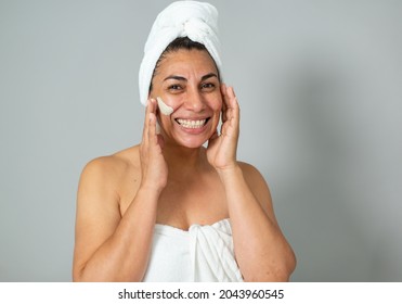 Hispanic Woman Touching Face During Skin Care Routine