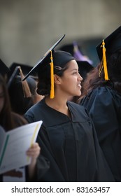 Hispanic Woman Wearing Graduation Hat And Gown