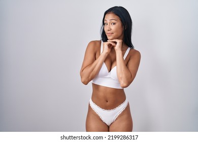 Hispanic Woman Wearing Lingerie Laughing Nervous And Excited With Hands On Chin Looking To The Side 