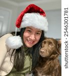 Hispanic Woman Wearing Santa Hat Takes Selfie With Dog On Christmas Eve 