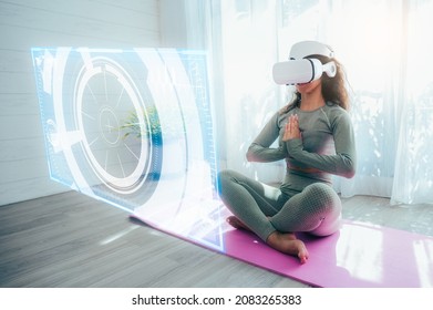 The Hispanic woman wearing VR goggles and doing Yoga and dancing at home, the concept of metaverse, versual really, activity, cyberspace and future - Shutterstock ID 2083265383