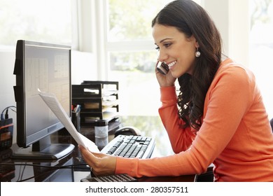 Hispanic Woman Working In Home Office