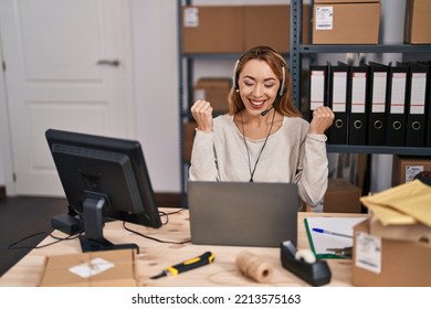 Hispanic Woman Working At Small Business Ecommerce Wearing Headset Screaming Proud, Celebrating Victory And Success Very Excited With Raised Arms 