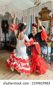 Hispanic Women Dancing Sevillanas In Tent