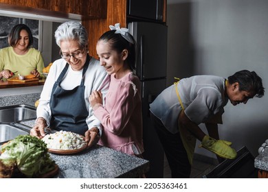 Hispanic Women Family Grandmother, Mother And Granddaughter Cooking At Home At Kitchen In Mexico Latin America