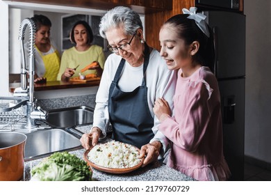 Hispanic Women Grandmother And Granddaughter Cooking At Home Kitchen In Mexico Latin America