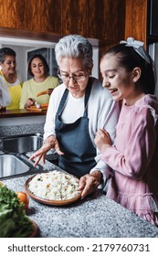 Hispanic Women Grandmother And Granddaughter Cooking At Home Kitchen In Mexico Latin America