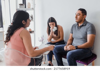 Hispanic Young Woman Psychologist With Couple Patient Crying In Therapy Talking About Mental Problems While Doctor Is Listening And Making Notes In Mexico Latin America