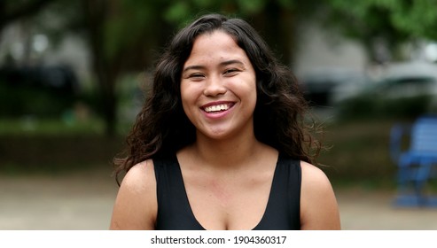 Hispanic Young Woman Smiling To Camera At Park, Casual Real People Series