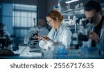 Hisplanic Female Bioengineer Looking at DNA Samples Under a Microscope in a Modern Applied Science Laboratory. Portrait of a Young Lab Engineer in White Coat Inventing New Medical Drugs