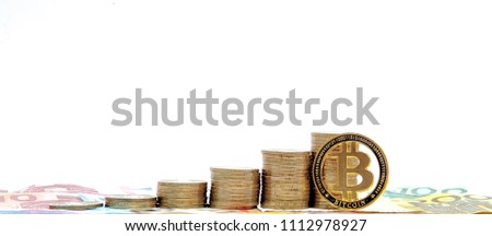 Histograma of coins and bitcoin on the white background. Concept of currency growth, savings.
