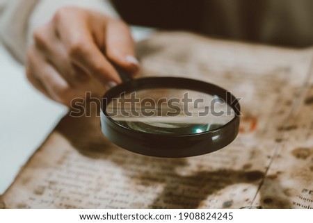  Historian scientist reading antique book with magnifying glass. Translation of religious literature. Manuscript with ancient writings. Treasures of the past. Museum piece