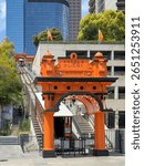 Historic Angels Flight funicular at its lower station, surrounded by modern skyscrapers and urban greenery in downtown Los Angeles, California, USA