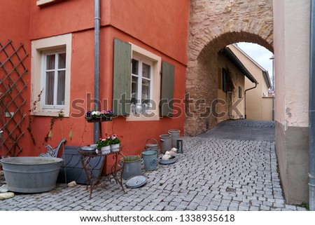 historic arch of the defense wall of the medieval imperial palace in Ingelheim (Germany) integrated between two later built houses in the street 