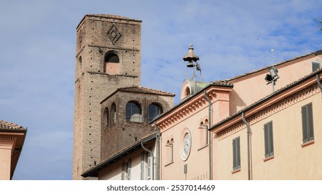 Historic architecture in Alba, Italy with a prominent clock tower and rustic buildings - Powered by Shutterstock