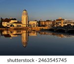 Historic Art Deco Building in downtown St Charles Illinois reflected in the Fox River at sunset