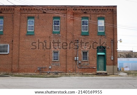 A historic brick building with green trim in Pacific, Missouri