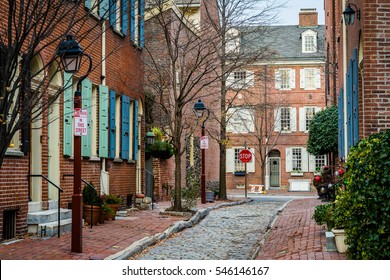 Historic brick houses and narrow cobblestone alley in Society Hill, Philadelphia, Pennsylvania.