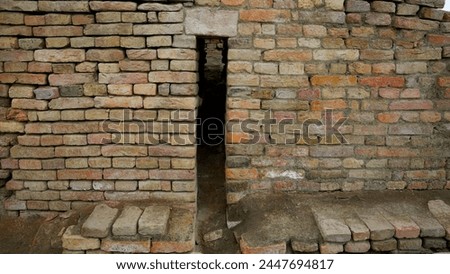 Historic brick wall featuring a slim vertical entrance, reflecting aged architectural styles Mohenjo Daro