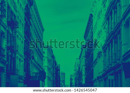 Historic buildings on Greene Street in the SoHo neighborhood of Manhattan in New York City with green and blue dutone color effect