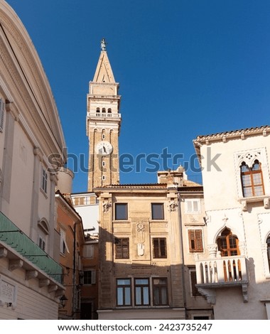 Historic buildings in Tartini Square in the medieval centre of Piran on the coast of Slovenia. The belltower of St George's Parish Church is in the background