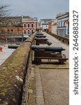 Historic cannons are positioned atop the ancient Londonderry City Walls, offering a glimpse into the city