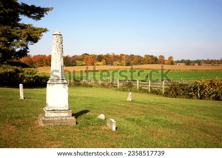 Historic church cemetery. Rural countryside. Country. Pasture. Woods. Fall. Autumn. Monument. Fence. Cornfield. Farm. Pasture. Graveyard. History. Pastoral. Peaceful.