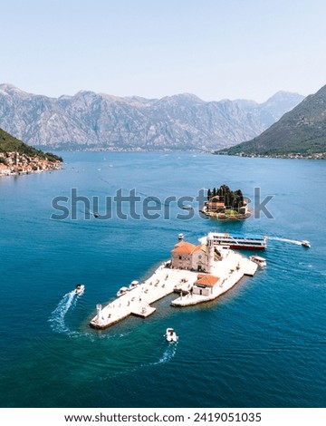 Historic city of Perast, Montenegro at Bay of Kotor in summer. Beautiful old buildings and coastlines. Boats on Lake.
