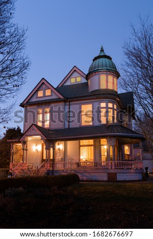 Historic classic Queen Anne Victorian house at dusk in the Indianapolis, Old Northside neighborhood