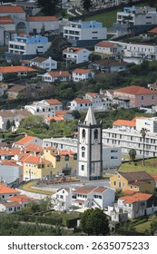 Historic clock tower (Torre do Relogio) dominating the landscape, offering vibrant urban views.One of the most symbolic architectural elements of the coastal town of Horta in Faial island
