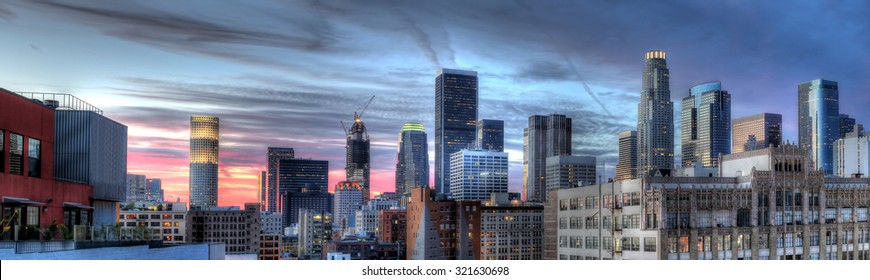 Historic Core and Financial District of Downtown Los Angeles during sunset.  The image shows smog and pollution.  All building logos has been edited out.
