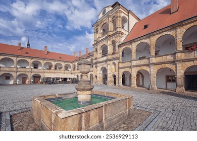 Historic courtyard in Moravska Trebova with fountain and stone architecture at a cultural heritage site on a sunny day - Powered by Shutterstock