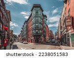Historic East End Boston Massachusetts United States brick buildings bakery restaurants and shops car street intersection landmark little Italy Italian American city town downtown area red orange USA
