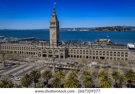 The historic Ferry Building with its iconic clock tower and palm trees stands on the San Francisco waterfront in San Francisco, United States