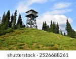 Historic fire lookout atop the alpine meadows of Lookout Mountain in the North Cascades range of Washington state. 