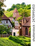 Historic half-timbered houses at market place of Maulbronn village, Baden-Württemberg (Germany). Renovated old monastery with convent, town hall, church, wine yards in idyllic scenery. Touristic site.